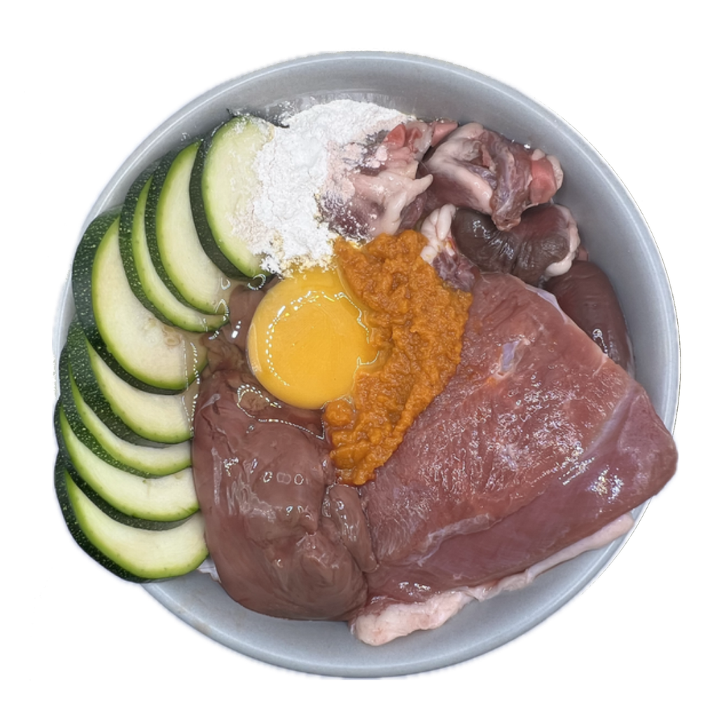 Fresh Duck Dog Food ingredients including duck meat, egg, and vegetables in a bowl.